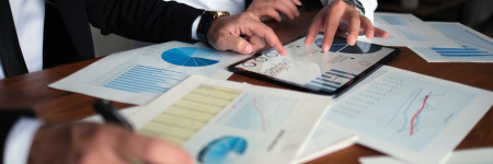 documents on a table with two people reviewing