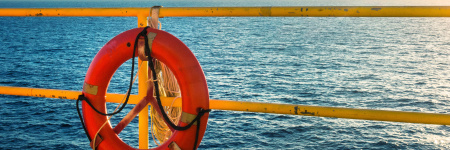 View of the water from the deck of a ship with a life saver